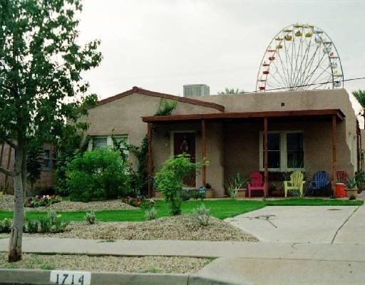 A Fairview Place home with the fairgrounds Ferris wheel rising behind it
