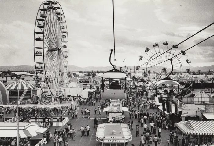 Vintage black and white photograph of the Arizona State Fair midway with Ferris wheel and sky ride