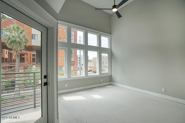 Shell-stage main living room with tall windows and city views at 210 W McKinley Street, Phoenix